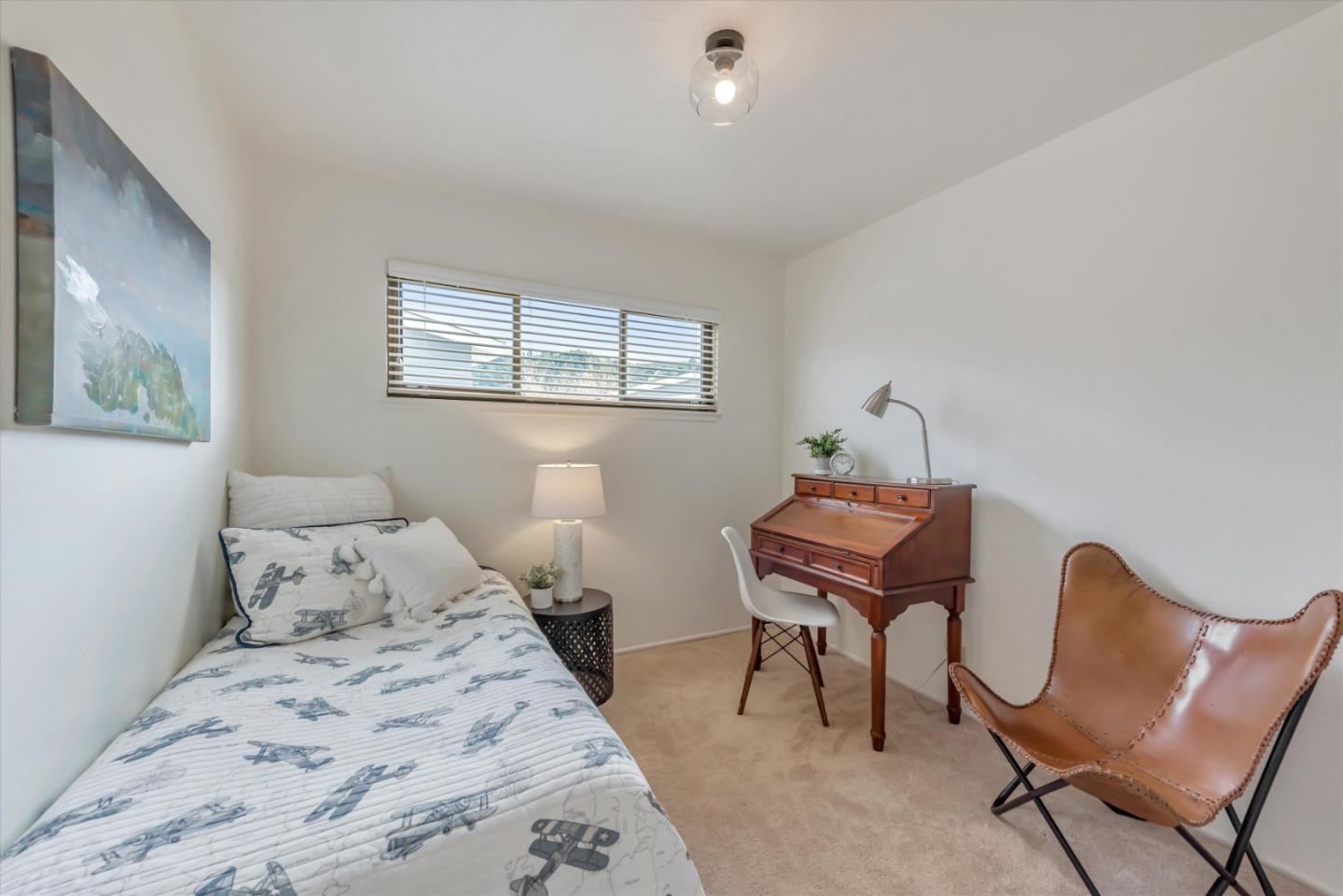 316 Greenway Drive Pacifica, CA 94044 - Photo 22 of 43 a bedroom with a bed chair and a desk