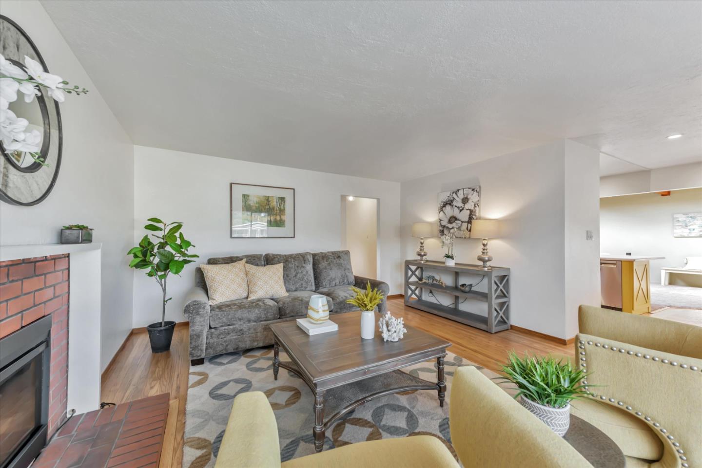 316 Greenway Drive Pacifica, CA 94044 - Photo 7 of 43 a living room with furniture a fireplace and a potted plant