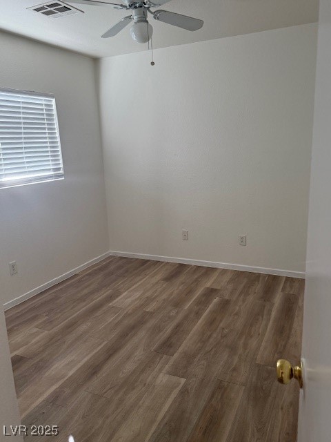 5474 Jacobs Field Street Las Vegas, NV 89148 - Photo 4 of 13 Unfurnished room featuring wood finished floors and ceiling fan
