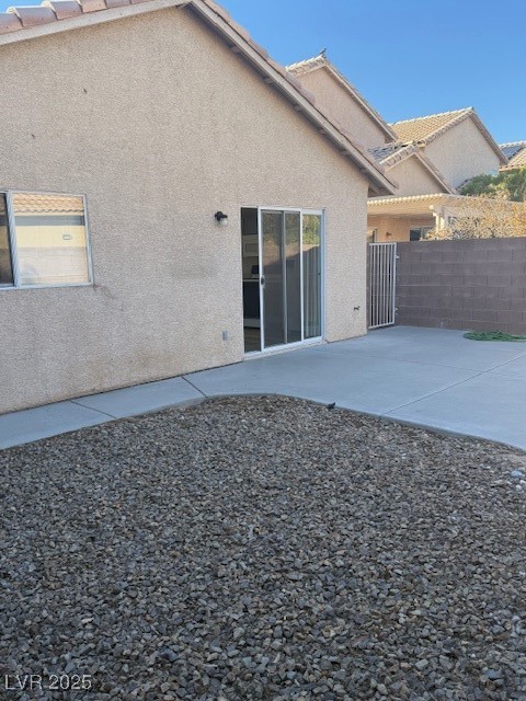 5474 Jacobs Field Street Las Vegas, NV 89148 - Photo 10 of 13 Rear view of property featuring stucco siding and a patio