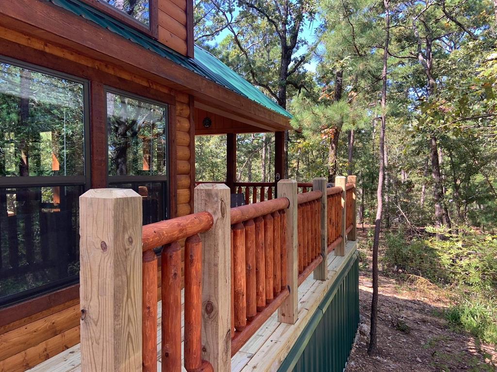 396 Choate Road Broken Bow, OK 74728 - Photo 18 of 19 a view of a deck with wooden fence and floor