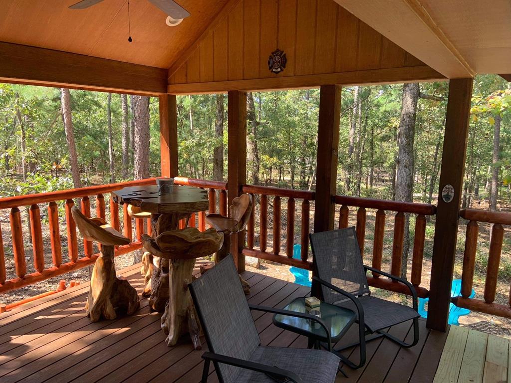 396 Choate Road Broken Bow, OK 74728 - Photo 19 of 19 a view of a porch with furniture and wooden floor