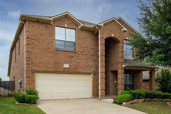 a front view of a house with garage