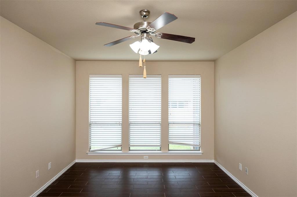7607 Yearling Way Arlington, TX 76002 - Photo 11 of 25 an empty room with wooden floor chandelier and windows