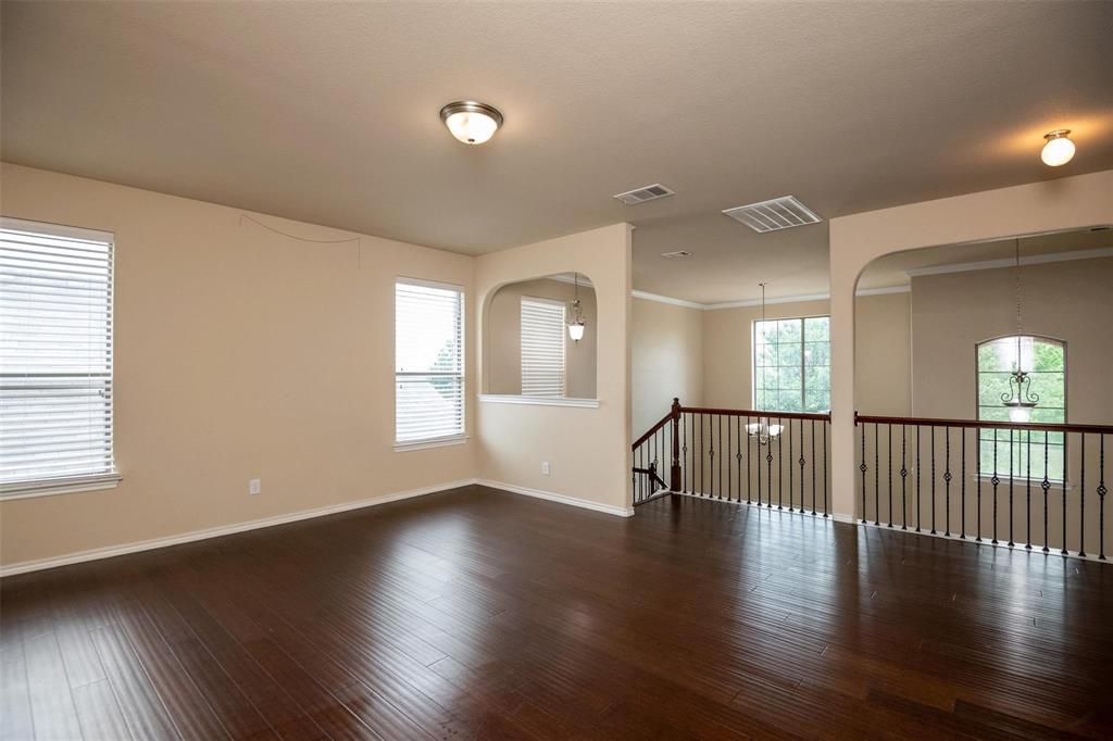 7607 Yearling Way Arlington, TX 76002 - Photo 14 of 25 an empty room with wooden floor and windows