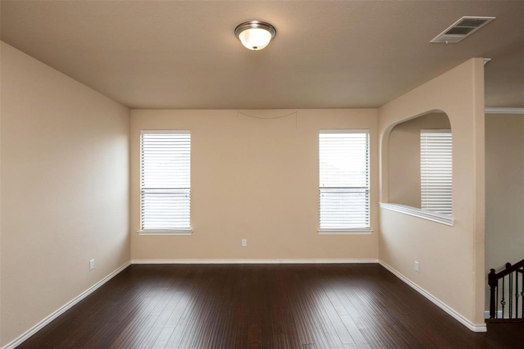 7607 Yearling Way Arlington, TX 76002 - Photo 15 of 25 an empty room with wooden floor and windows