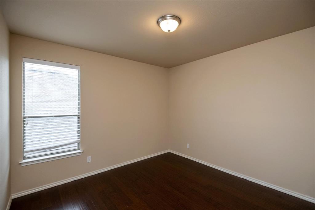 7607 Yearling Way Arlington, TX 76002 - Photo 17 of 25 an empty room with wooden floor and windows