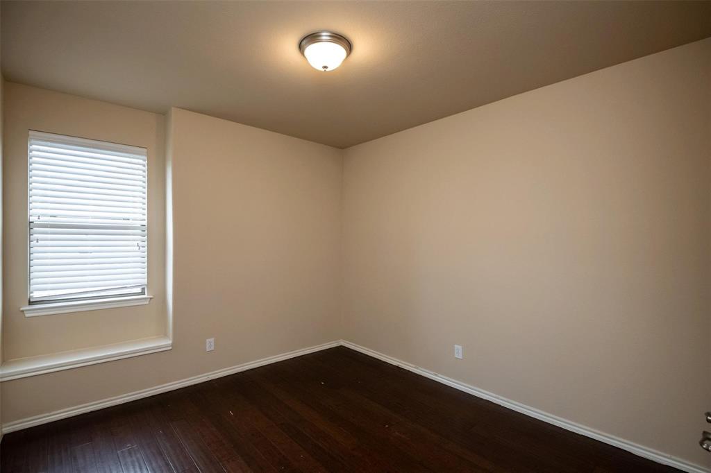 7607 Yearling Way Arlington, TX 76002 - Photo 18 of 25 an empty room with wooden floor and windows