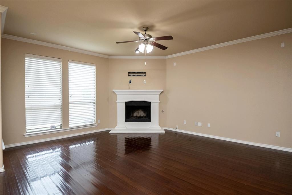7607 Yearling Way Arlington, TX 76002 - Photo 9 of 25 a view of a livingroom with a fireplace a ceiling fan and wooden floor