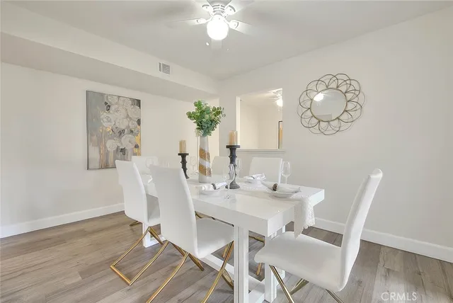 a view of a dining room with furniture and wooden floor