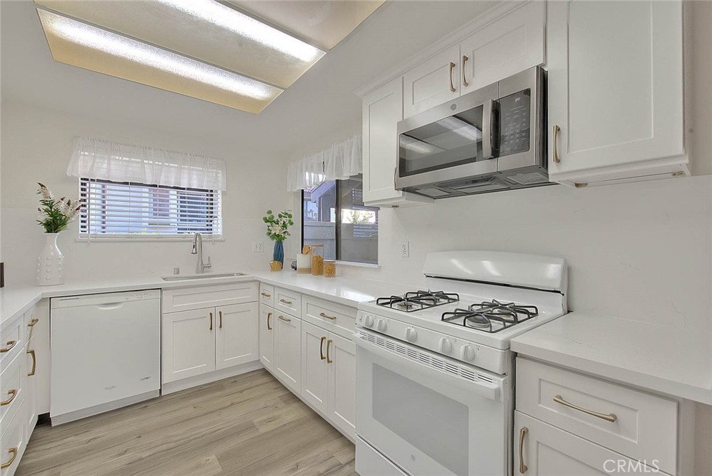 1540 Corte Hacienda Upland, CA 91786 - Photo 24 of 66 a kitchen with granite countertop cabinets stainless steel appliances and wooden floor