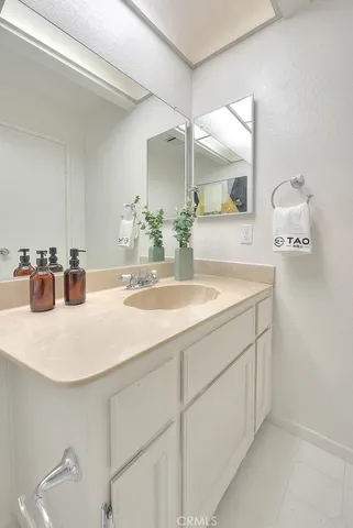 a view of staircase with lots of frames on wall and shower