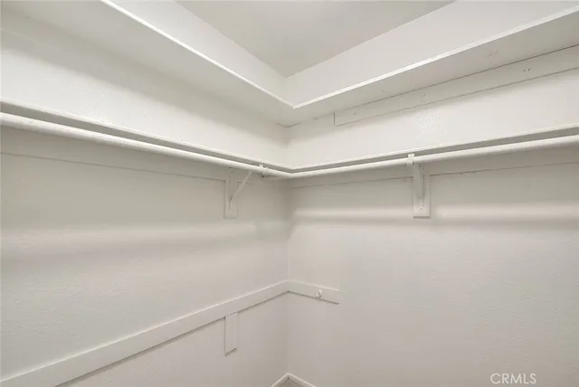 an aerial view of residential houses with outdoor space and parking