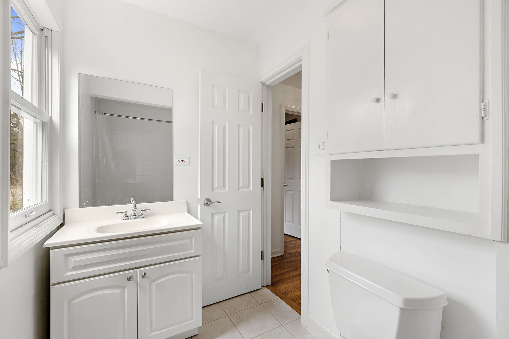 619 Forest Road Glenview, IL 60025 - Photo 17 of 28 a bathroom with a sink and a mirror