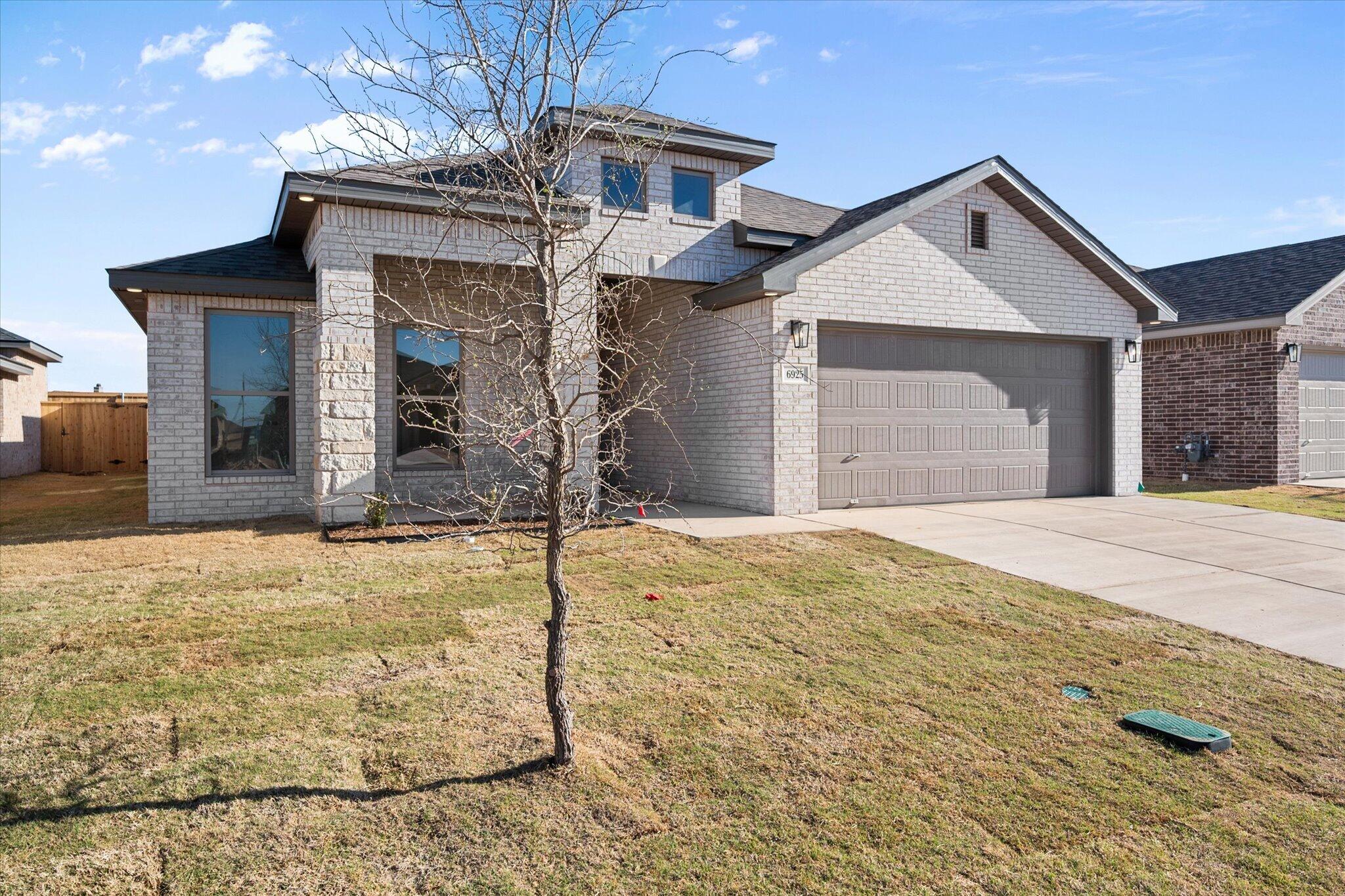 6925 53rd Street Lubbock, TX 79407 - Photo 1 of 22 a view of a house with snow on the road
