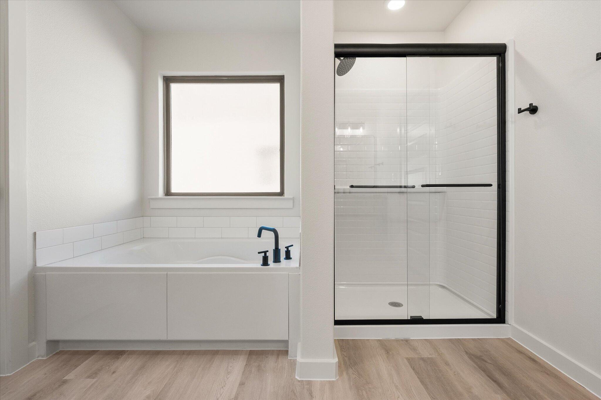 6925 53rd Street Lubbock, TX 79407 - Photo 13 of 22 a white bath tub sitting next to a white sink