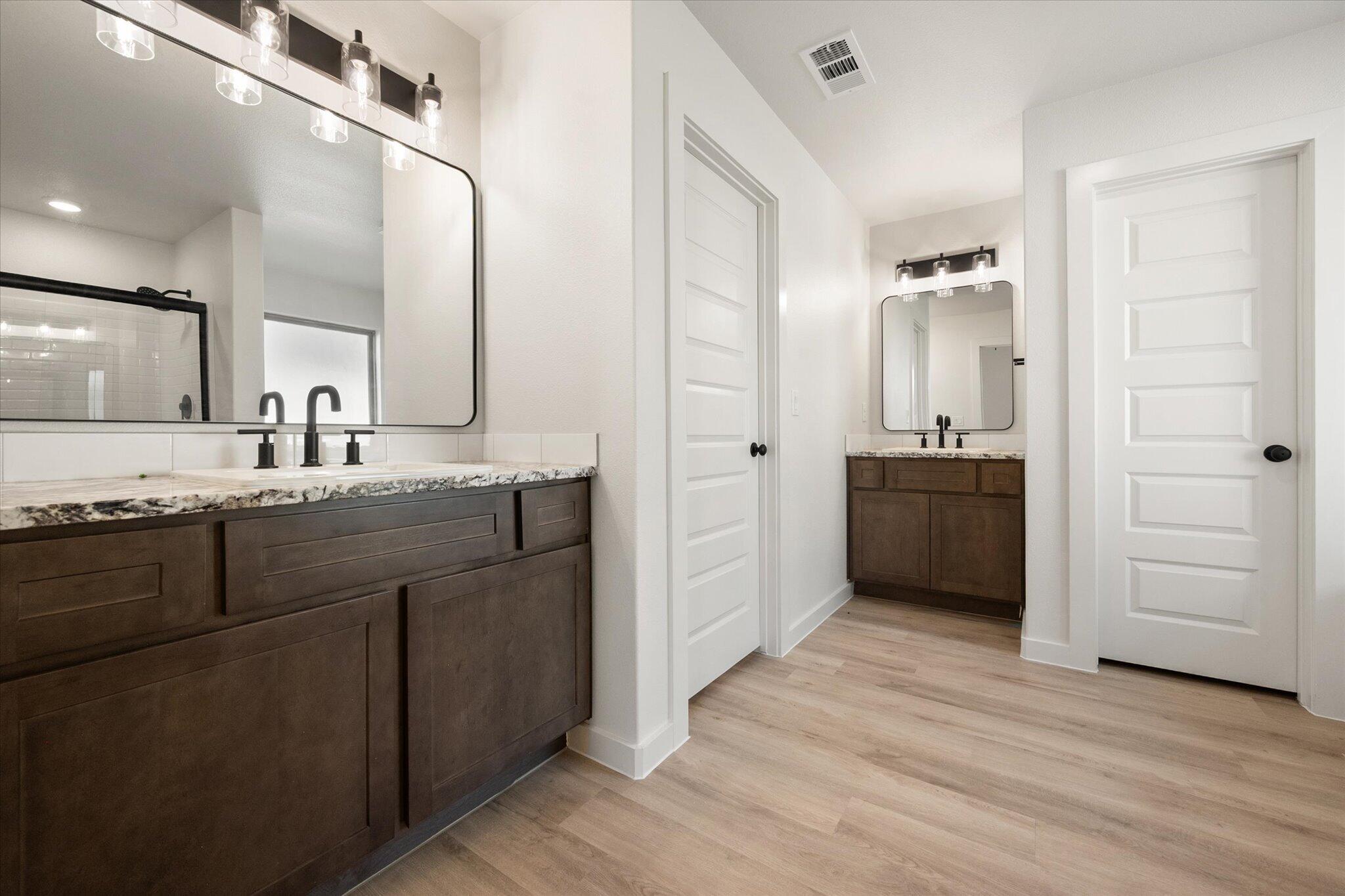 6925 53rd Street Lubbock, TX 79407 - Photo 15 of 22 a spacious bathroom with a granite countertop sink mirror and