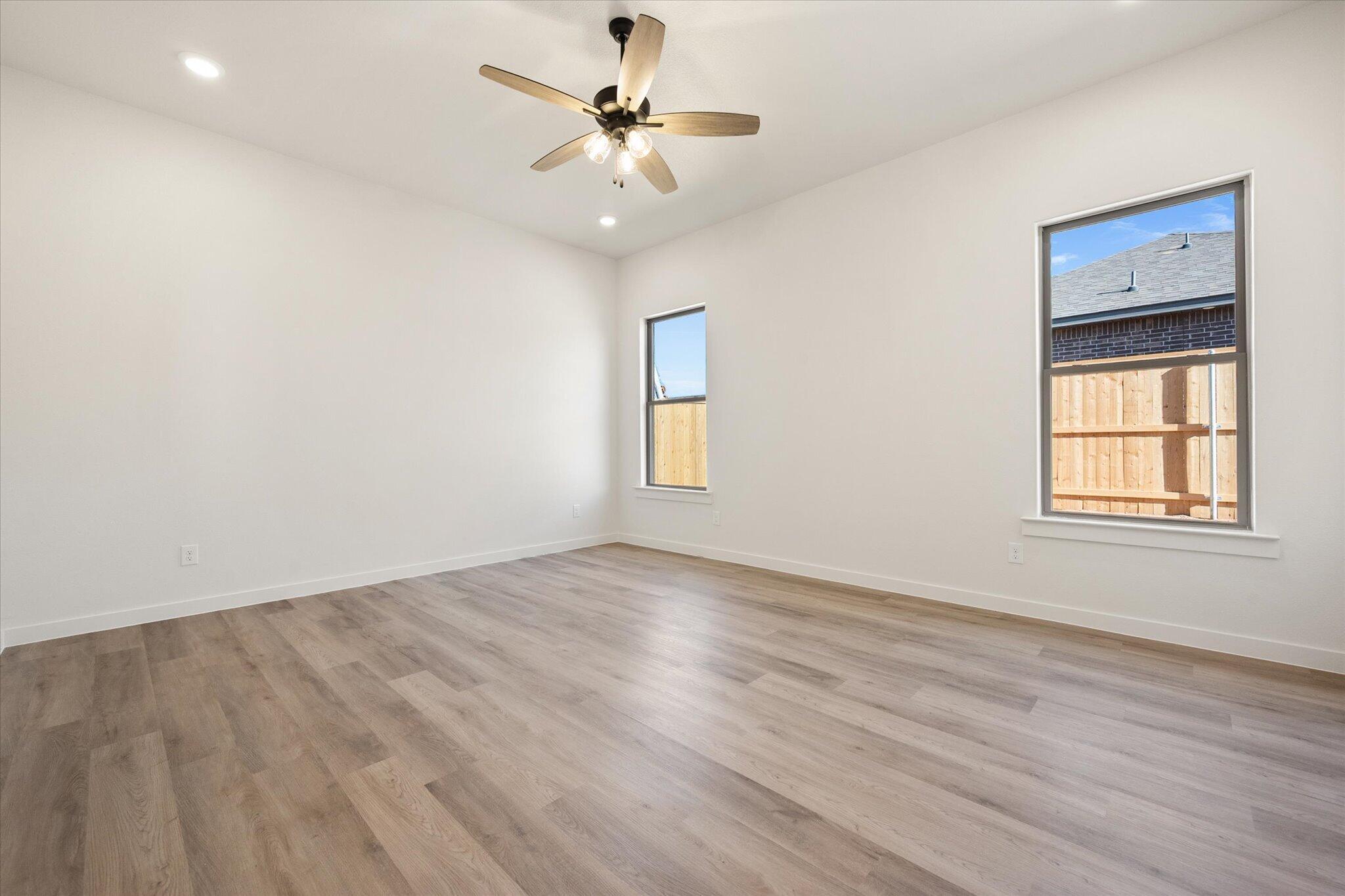 6925 53rd Street Lubbock, TX 79407 - Photo 17 of 22 wooden floor in an empty room with a window