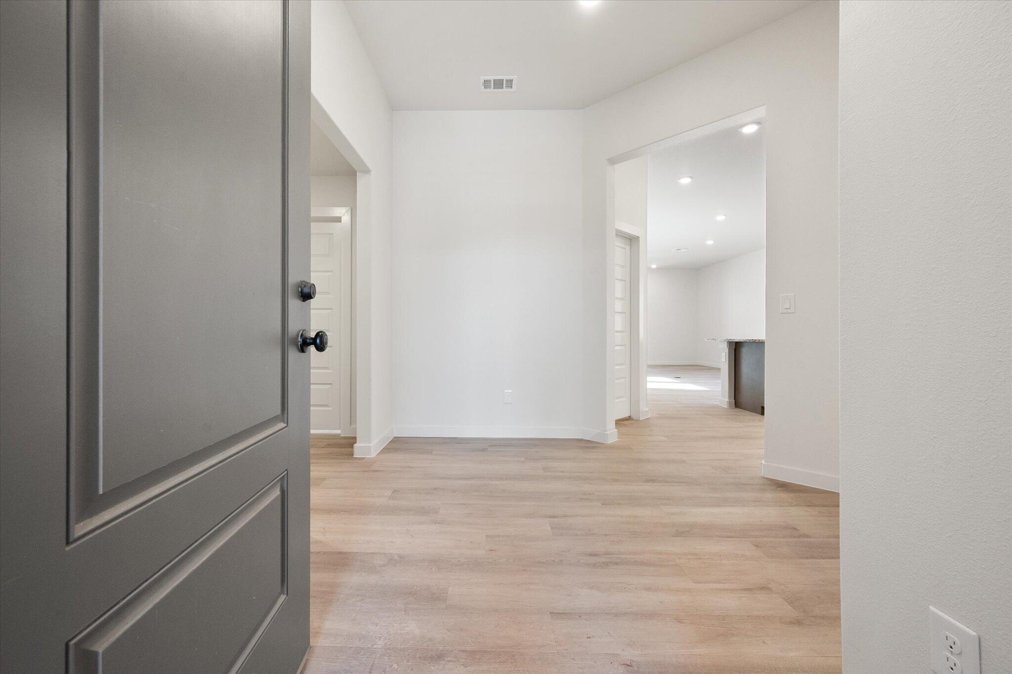6925 53rd Street Lubbock, TX 79407 - Photo 3 of 22 a view of a hallway with wooden floor