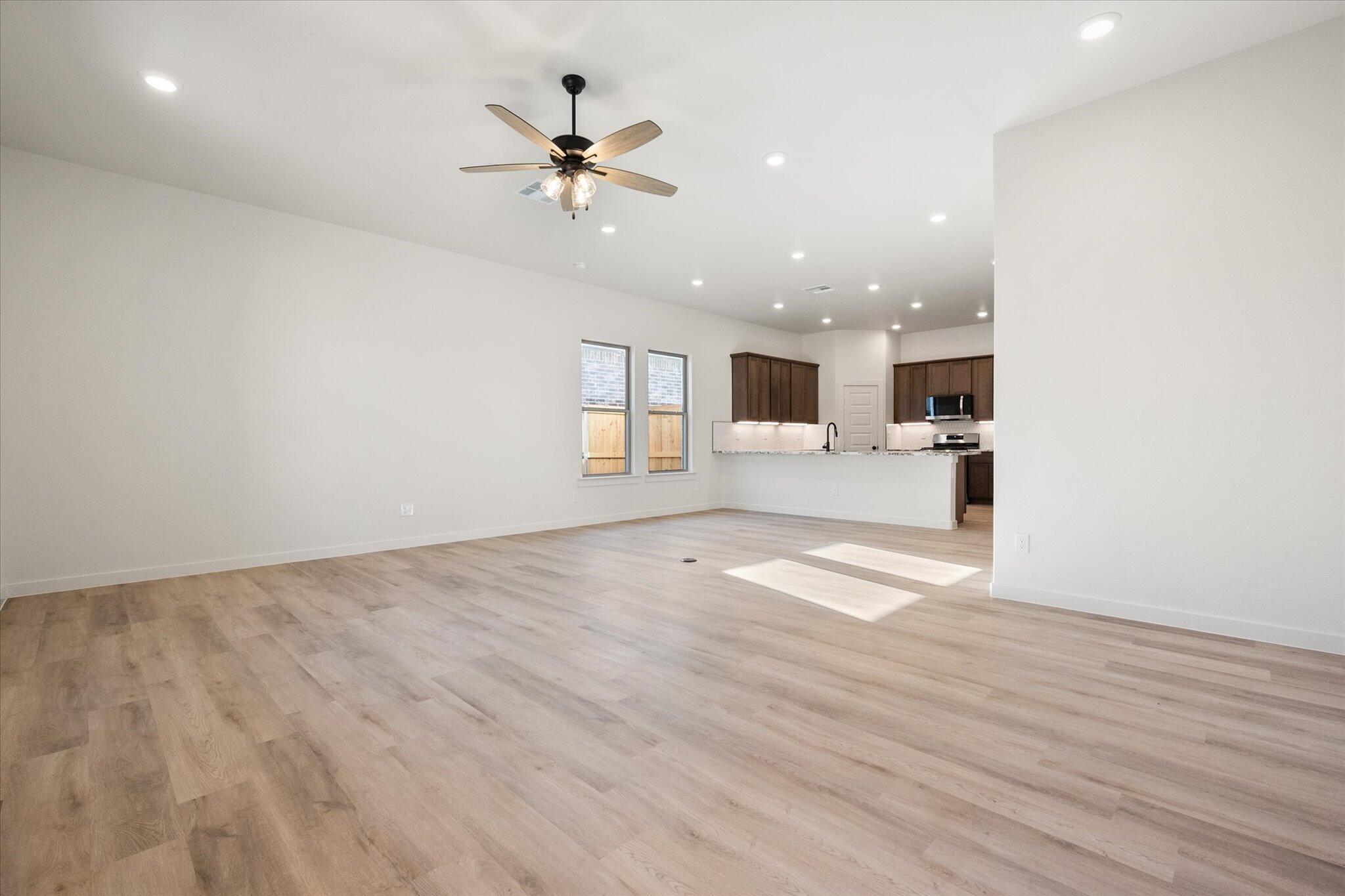 6925 53rd Street Lubbock, TX 79407 - Photo 5 of 22 an empty room with wooden floor and windows
