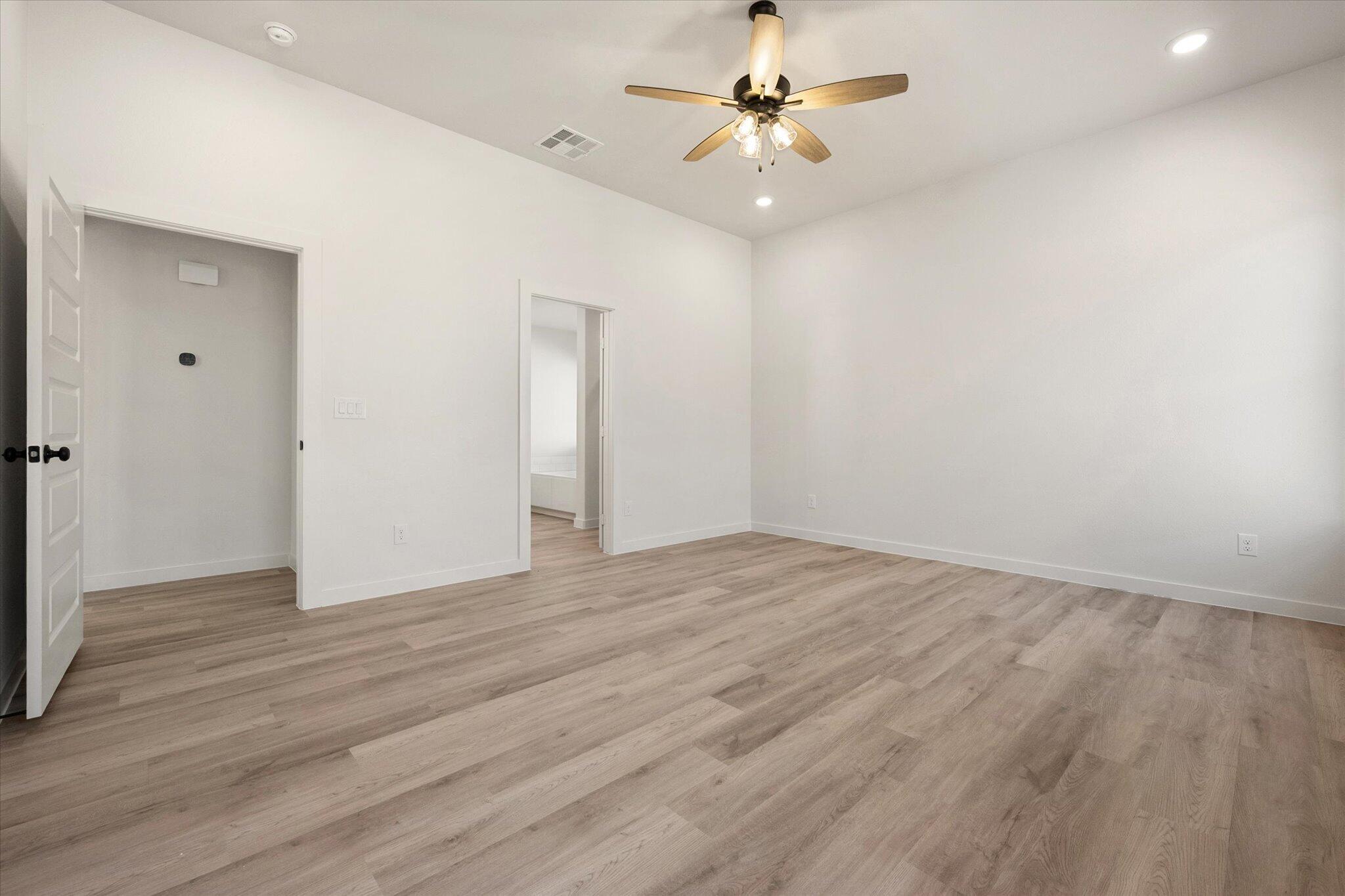 6925 53rd Street Lubbock, TX 79407 - Photo 10 of 22 a view of an empty room with a fan