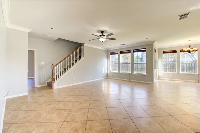 a view of an entryway with floor to ceiling windows and a chandelier