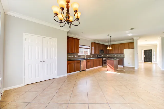 a view of kitchen with a sink refrigerator and window