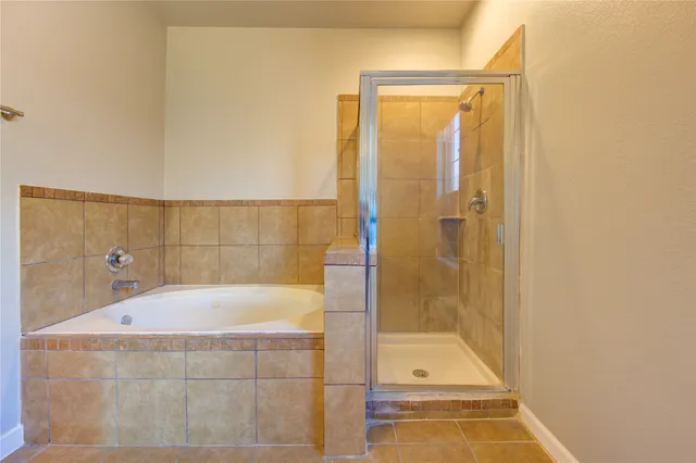 a bathroom with a tub and shower