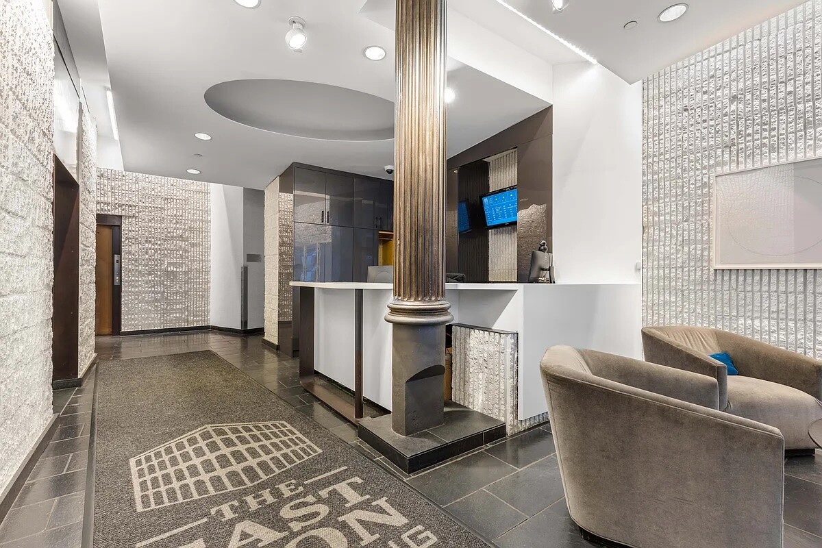 67 East 11th Street, Unit 503 Manhattan, NY 10003 - Photo 9 of 10 a living room with furniture and a rug