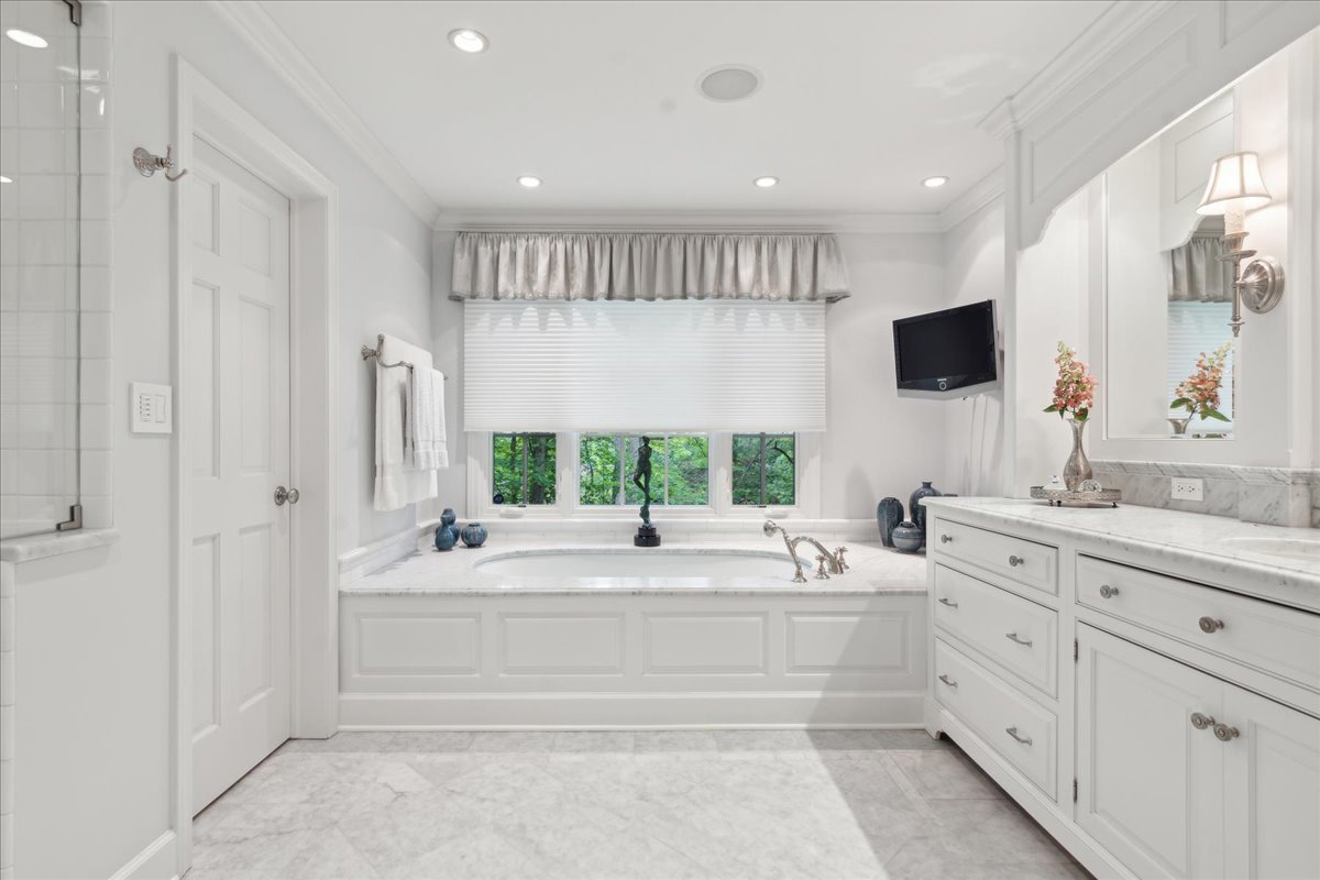1213 Turicum Road Lake Forest, IL 60045 - Photo 27 of 59 a bathroom with a double vanity sink a mirror and a bathtub