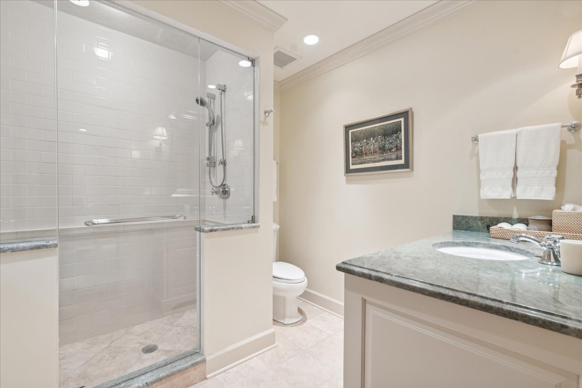 1213 Turicum Road Lake Forest, IL 60045 - Photo 35 of 59 a bathroom with a granite countertop sink a toilet a mirror and shower