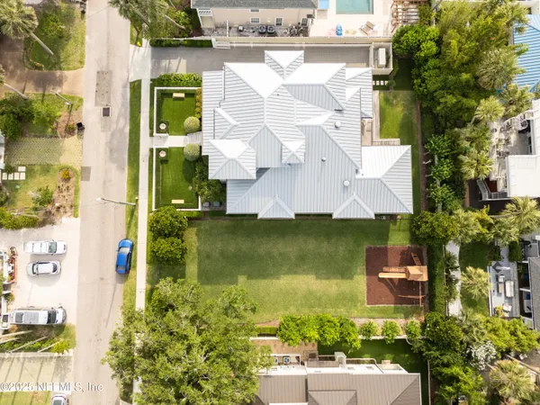 an aerial view of a house with a garden statue