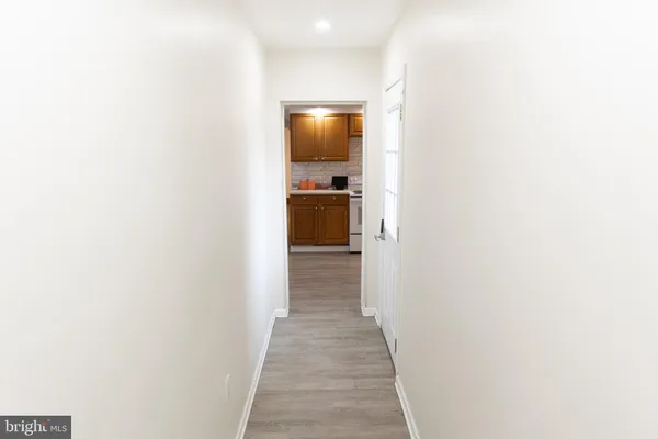 a view of entryway and hall with wooden floor