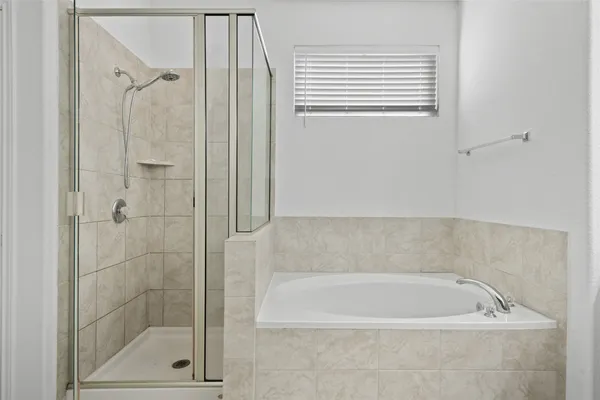 a bathroom with a bath tub and a shower