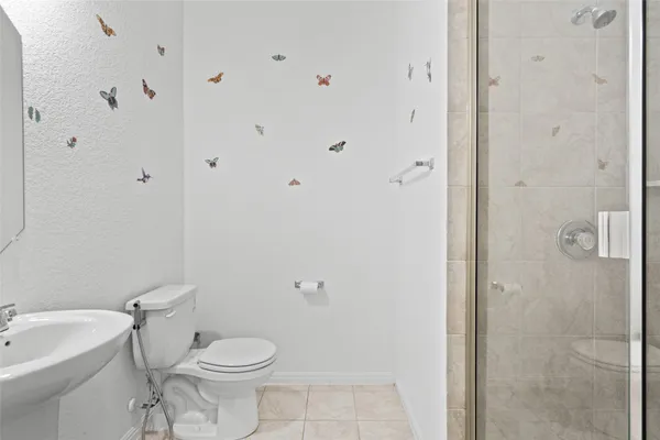 a white toilet sitting next to a bathroom sink