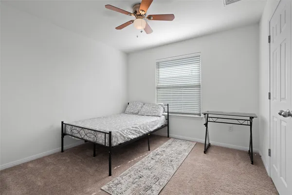 a bedroom with a bed and white walls