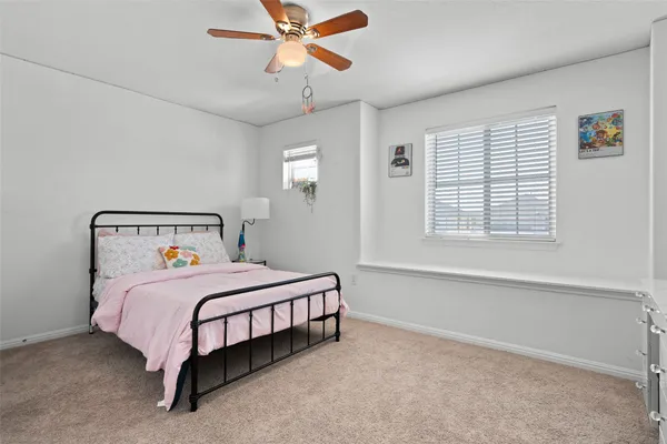 a bedroom with a bed and window