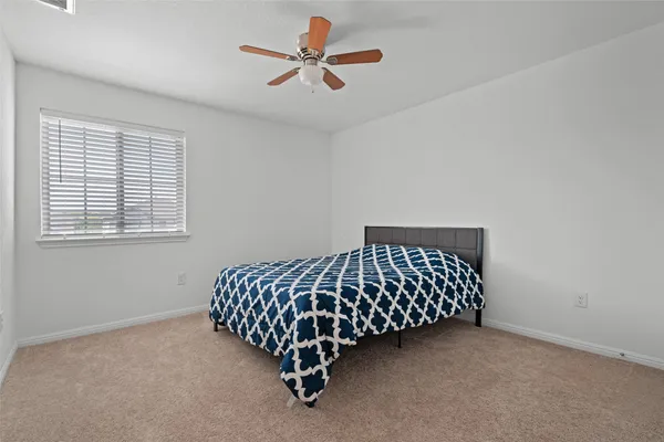 a bed sitting in a bedroom next to a window