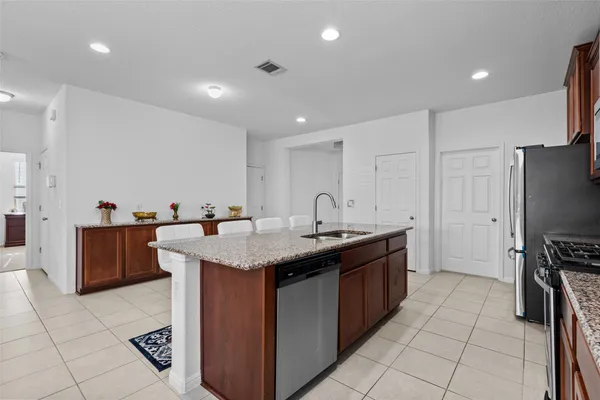 a kitchen with stainless steel appliances granite countertop a sink counter space and cabinets
