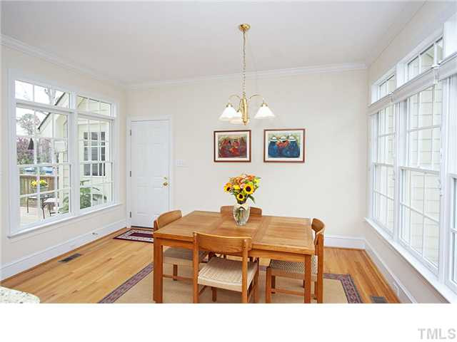 3312 Tall Tree Place Raleigh, NC 27607 - Photo 6 of 12 The breakfast room features crown molding, architectural windows with transoms and is open to the kitchen and family room. This room is large enough to fit a table/chairs and breakfront or fabulous buffet. Make it formal or casual... your choice. Breakfast Area