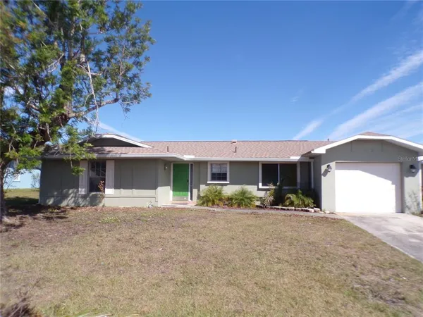 a front view of a house with a yard and a garage