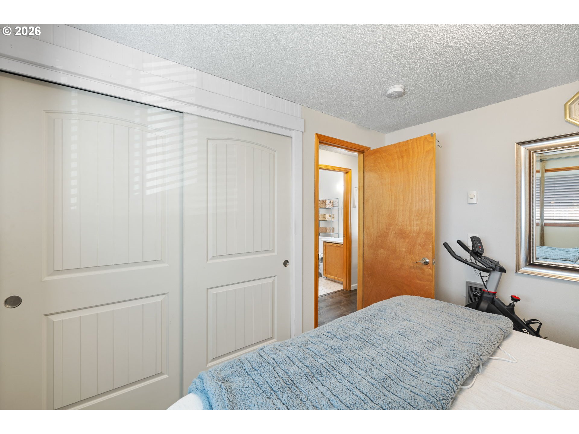 1480 Northeast Kane Drive Gresham, OR 97030 - Photo 17 of 46 a bedroom with a bed and wooden floor
