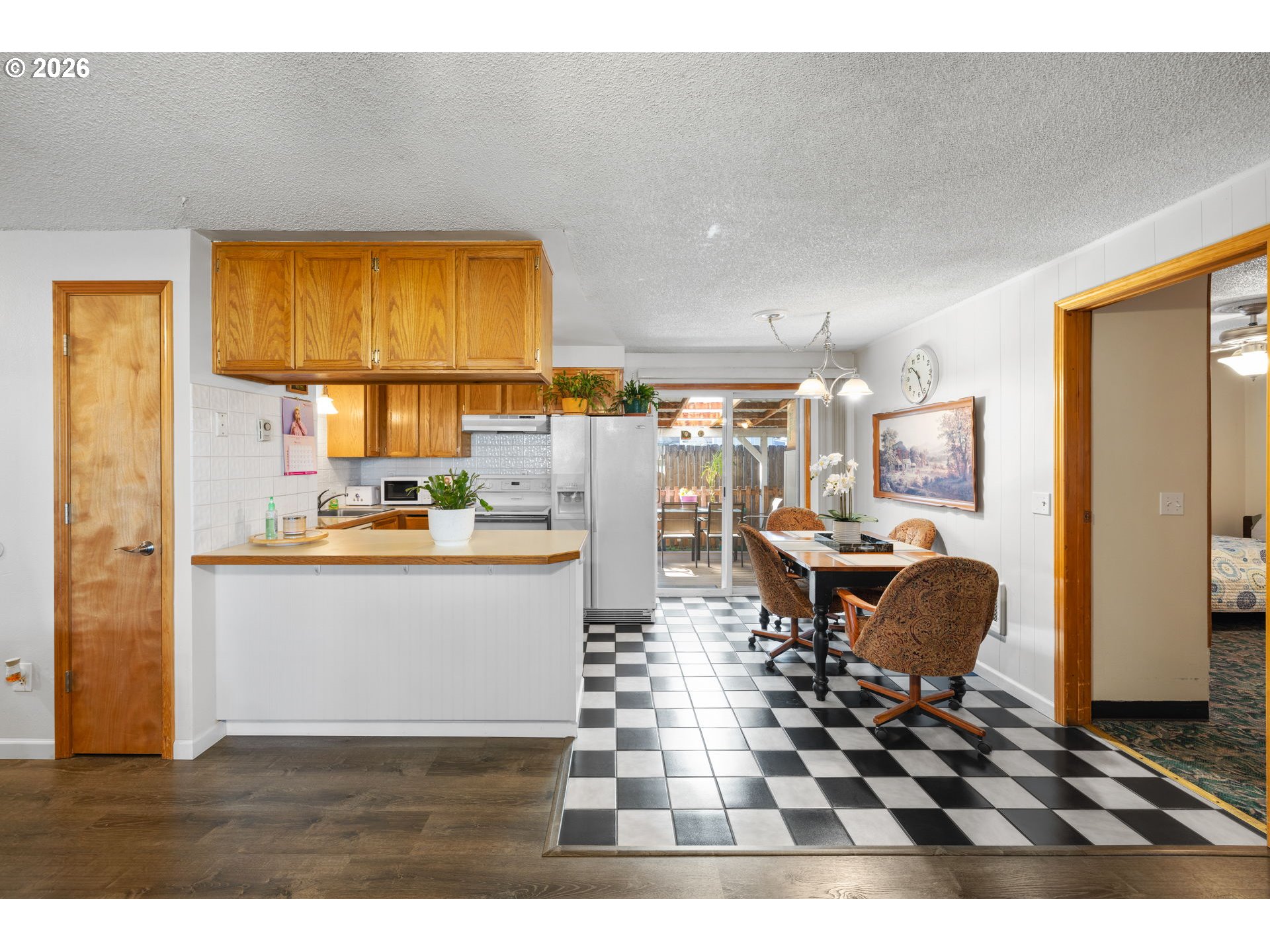 1480 Northeast Kane Drive Gresham, OR 97030 - Photo 23 of 46 a kitchen with stainless steel appliances kitchen island granite countertop a refrigerator and a sink
