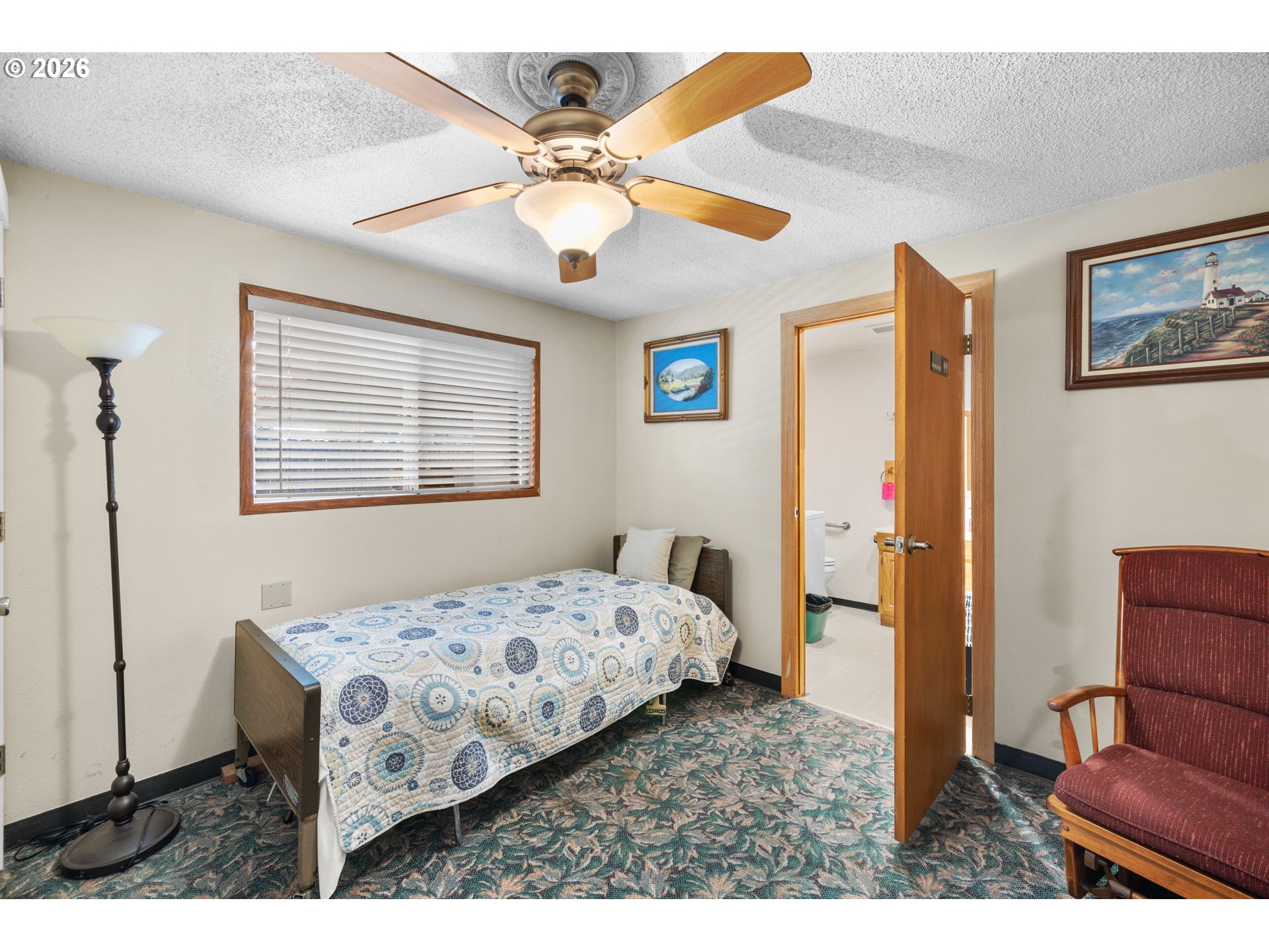 1480 Northeast Kane Drive Gresham, OR 97030 - Photo 32 of 46 a bedroom with a bed a couch and a chandelier