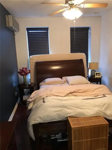 a bedroom with a bed and a chandelier