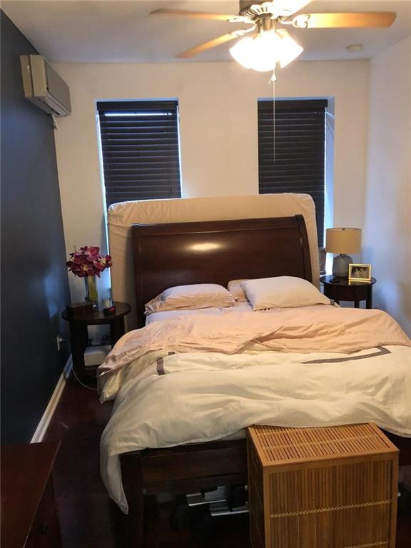 1635 83rd Street Brooklyn, NY 11214 - Photo 3 of 9 a bedroom with a bed and a chandelier