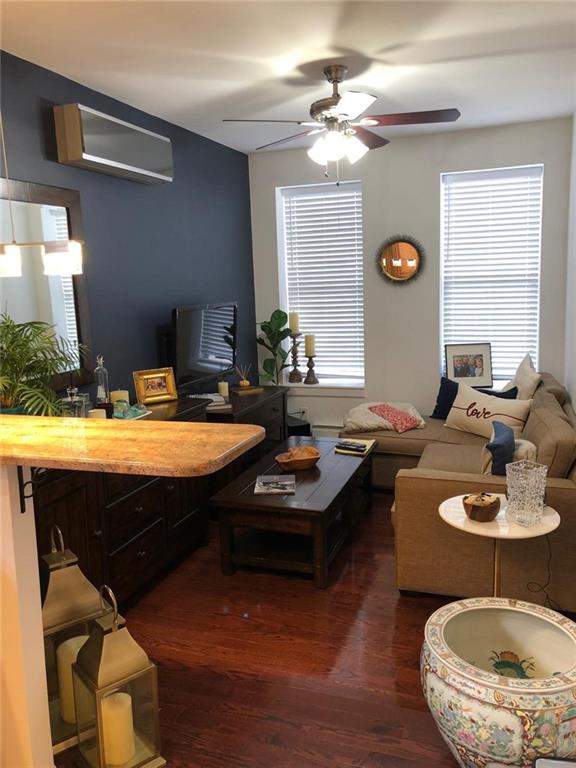 1635 83rd Street Brooklyn, NY 11214 - Photo 4 of 9 a living room with furniture and a fireplace