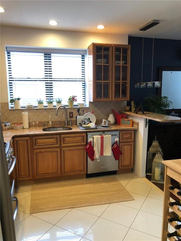 1635 83rd Street Brooklyn, NY 11214 - Photo 5 of 9 a kitchen with stainless steel appliances granite countertop a stove a sink and a microwave