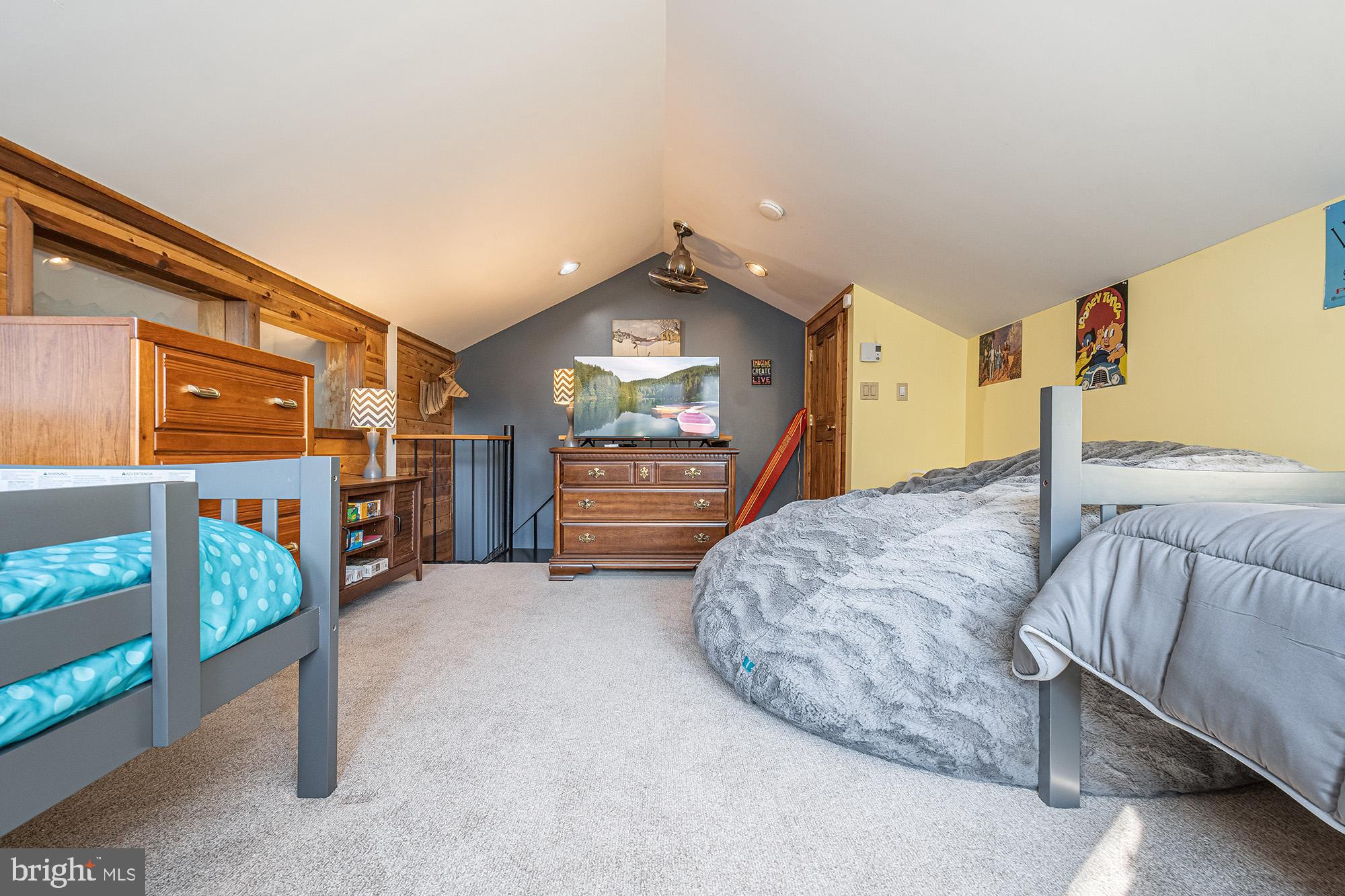 12 Winding Way, Unit 18A McHenry, MD 21541 - Photo 16 of 35 a bed sitting in a bedroom next to a lamp