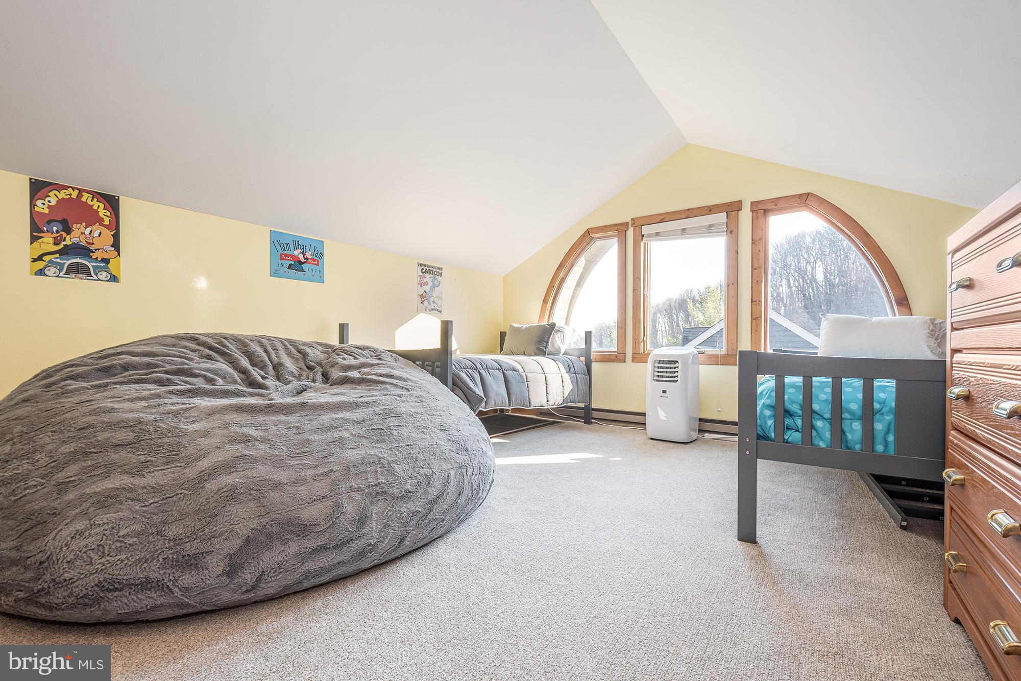 12 Winding Way, Unit 18A McHenry, MD 21541 - Photo 18 of 35 a spacious bedroom with a bed and a large window